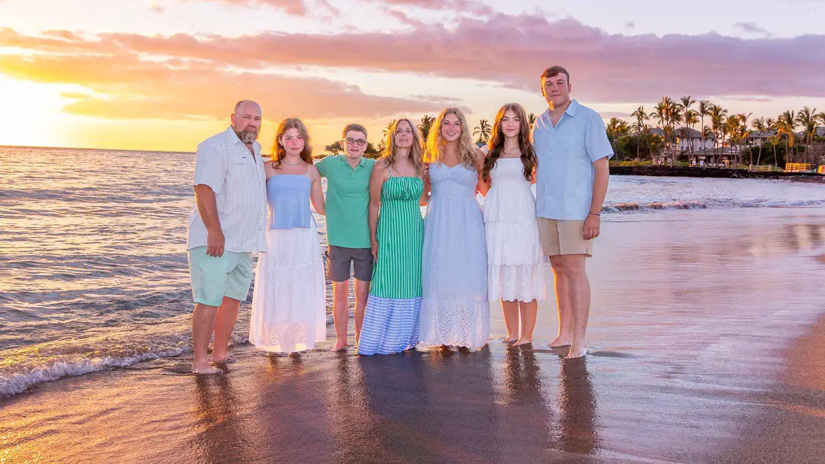 Family photographed on a Kailua-Kona beach at sunset during a Big Island beach photoshoot in Hawaii