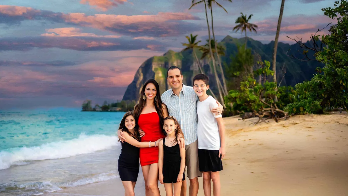 Family posing at sunset on an Oahu beach during a couples and families photoshoot in Hawaii